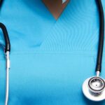 Health workers in the UK wearing blue medical scrubs
